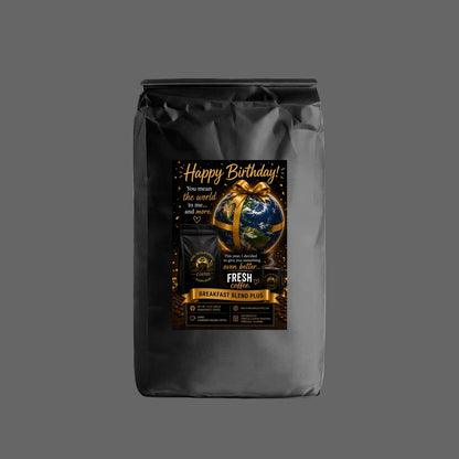 A black coffee bag with a custom 'Happy Birthday!' graphic label, featuring a gold ribbon, a globe, and gold lettering on a white background.