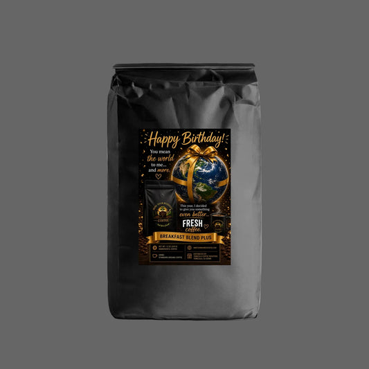 A black coffee bag with a custom 'Happy Birthday!' graphic label, featuring a gold ribbon, a globe, and gold lettering on a white background.